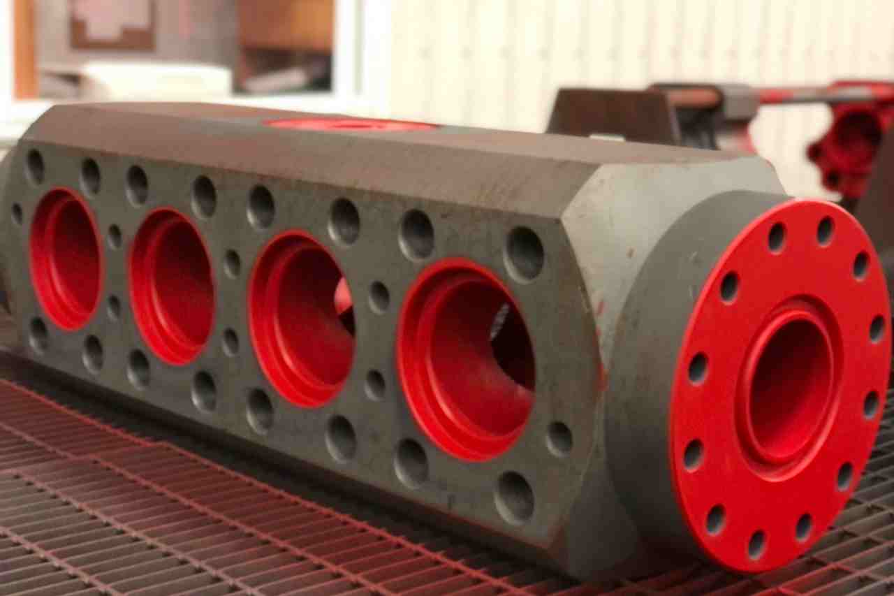 Metal equipment coated in a red fluoropolymer protective coating. 