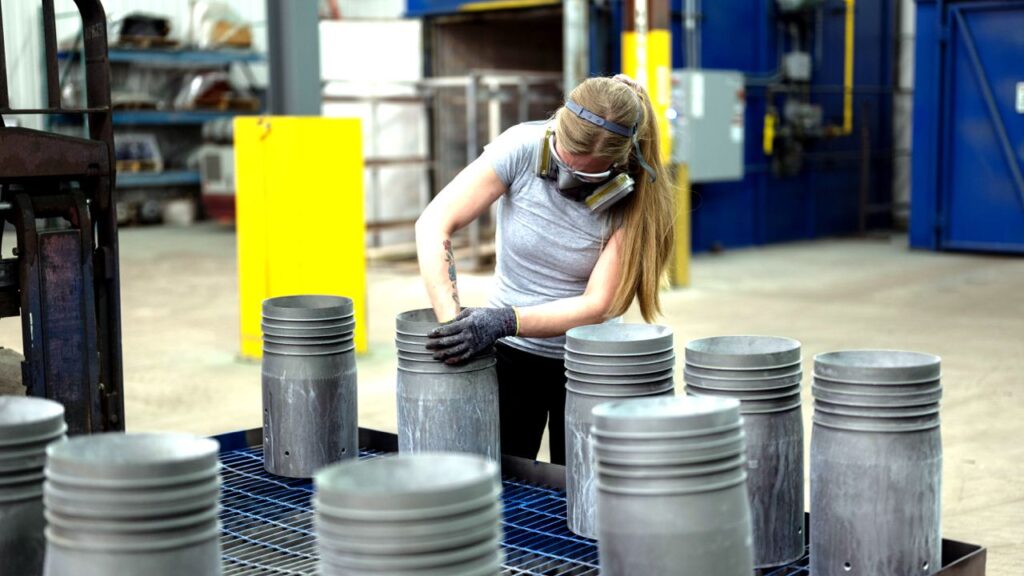 Girl coating pipes with an FBE coating