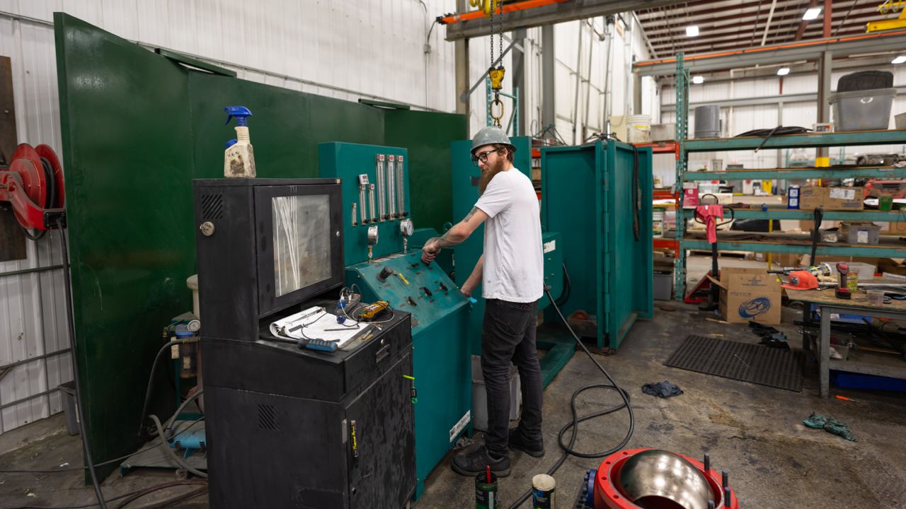 Man working at plant pulling levers