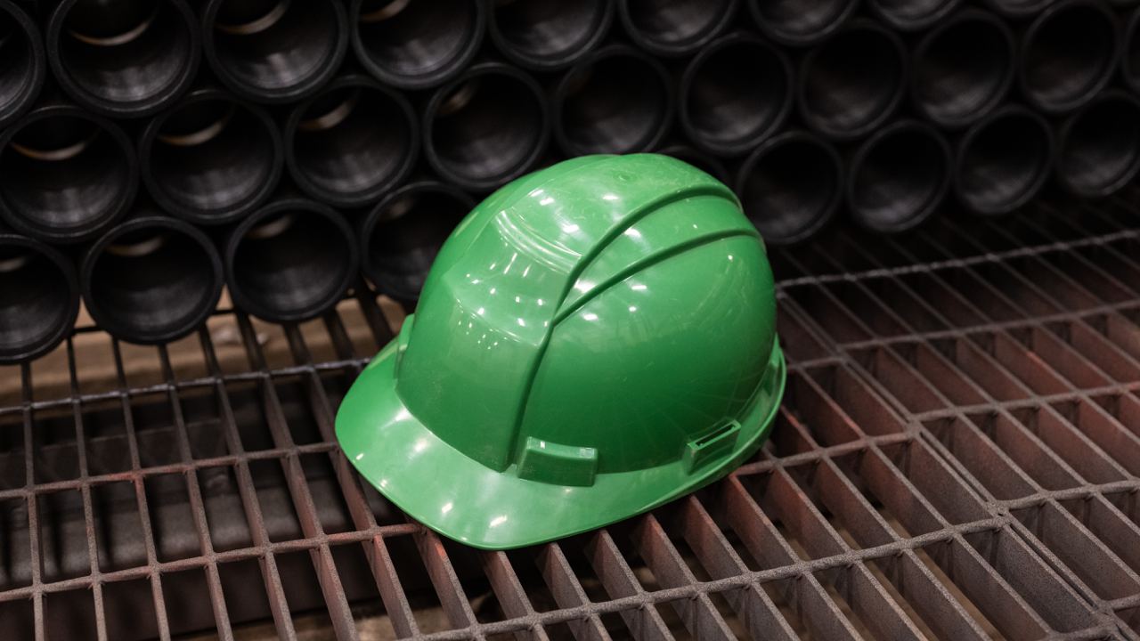 Green hard hat resting on ground