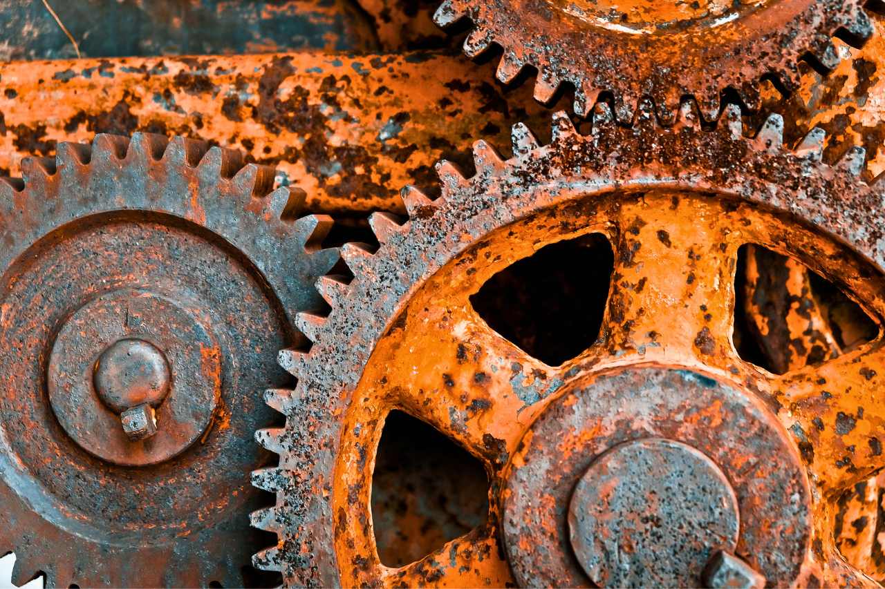 A close-up of gears that are covered in rust.