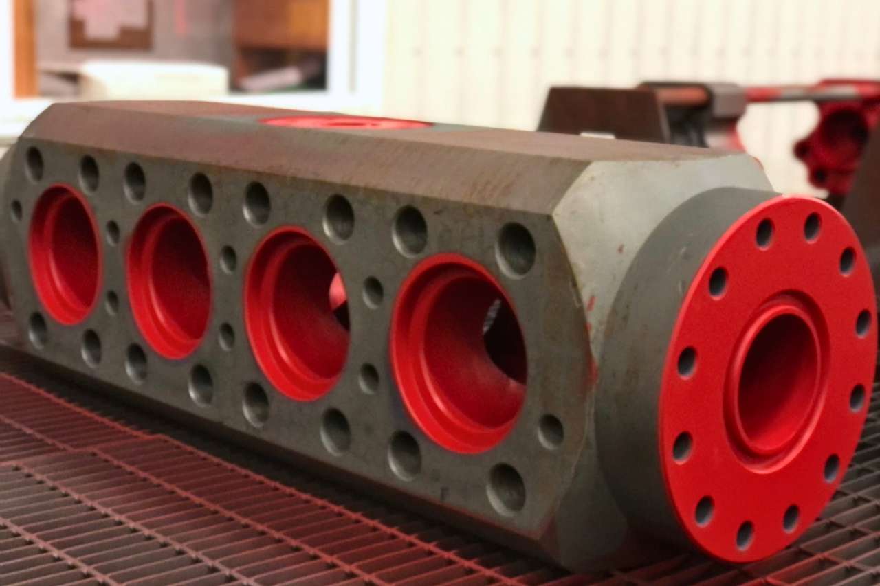 A piece of machinery that has a fluoropolymer protective coating in the colour red.